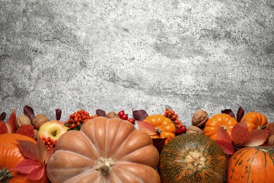 Photo of Flat lay composition with pumpkins and autumn leaves on grey table, space for text. Thanksgiving Day