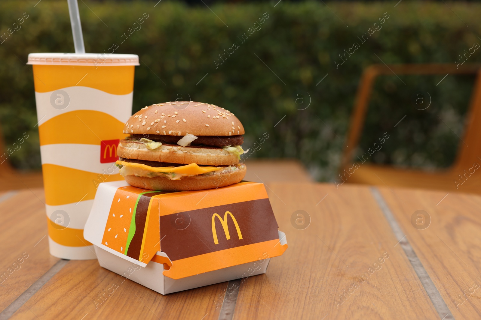 Photo of Lviv, Ukraine - October 9, 2023: McDonald's menu on wooden table outdoors, space for text