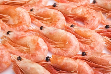 Photo of Raw shrimps covered with ice as background, closeup