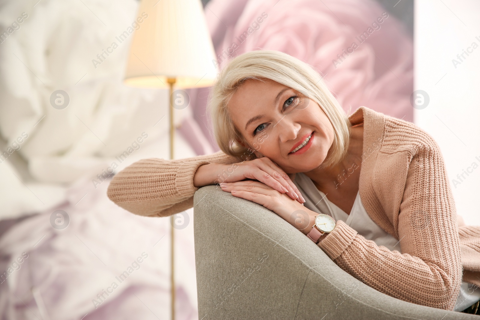 Photo of Beautiful mature woman on sofa at home