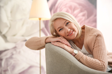 Photo of Beautiful mature woman on sofa at home