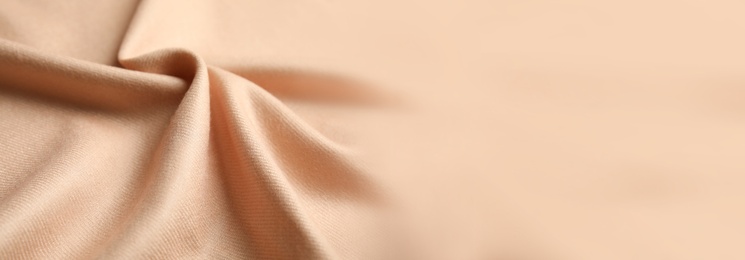 Image of Beige soft cashmere fabric as background, closeup view with space for text. Banner design
