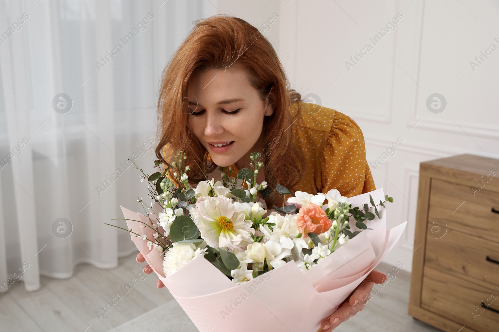 Photo of Beautiful woman with bouquet of flowers indoors