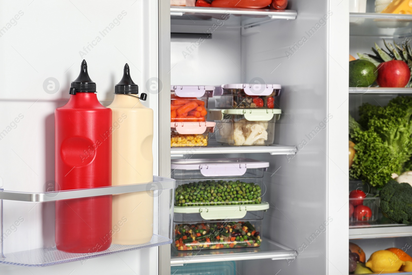 Photo of Open refrigerator full of different fresh products