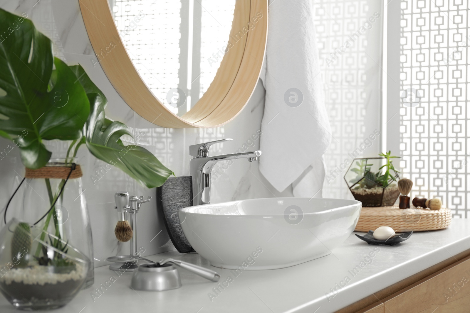 Photo of Stylish bathroom interior with vessel sink and mirror