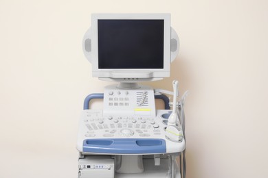 Ultrasound machine near white wall. Medical equipment