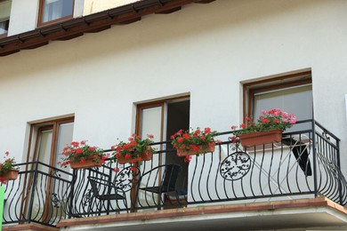 View of house with flowers on balcony railing