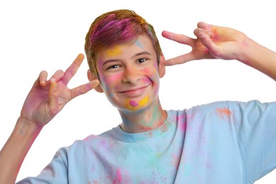 Photo of Teen boy covered with colorful powder dyes on white background. Holi festival celebration