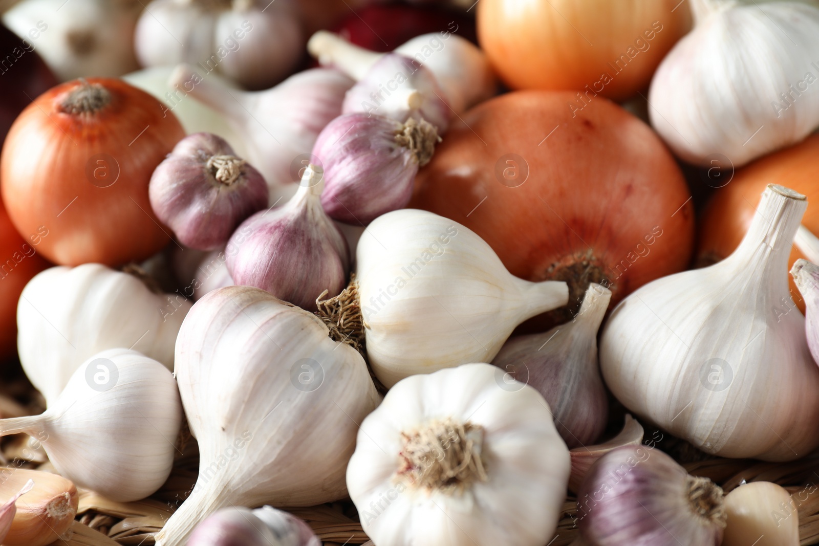 Photo of Fresh raw garlic and onions as background, closeup