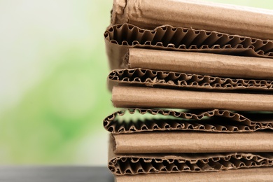 Photo of Stack of cardboard for recycling on blurred background, closeup. Space for text