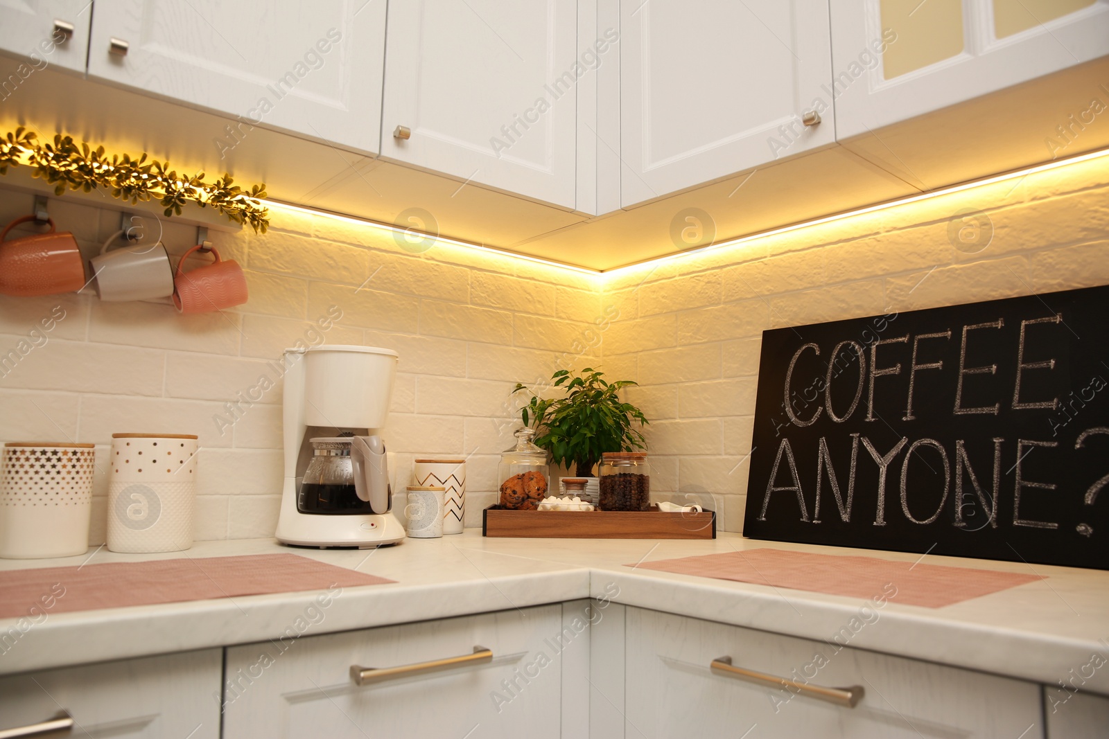 Photo of Stylish kitchen interior with modern coffeemaker on countertop