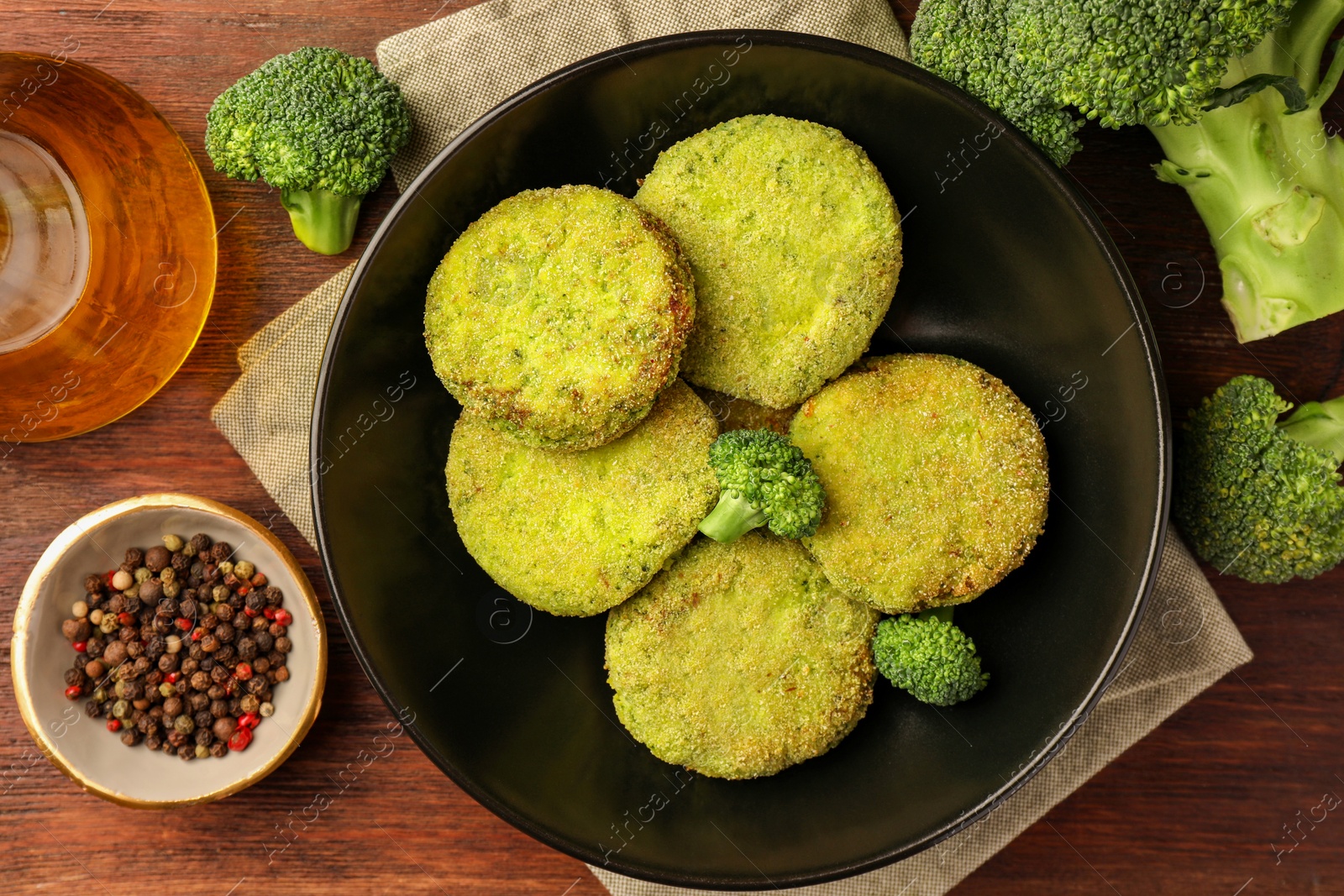 Photo of Tasty vegan cutlets and ingredients on wooden table, flat lay