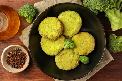 Photo of Tasty vegan cutlets and ingredients on wooden table, flat lay