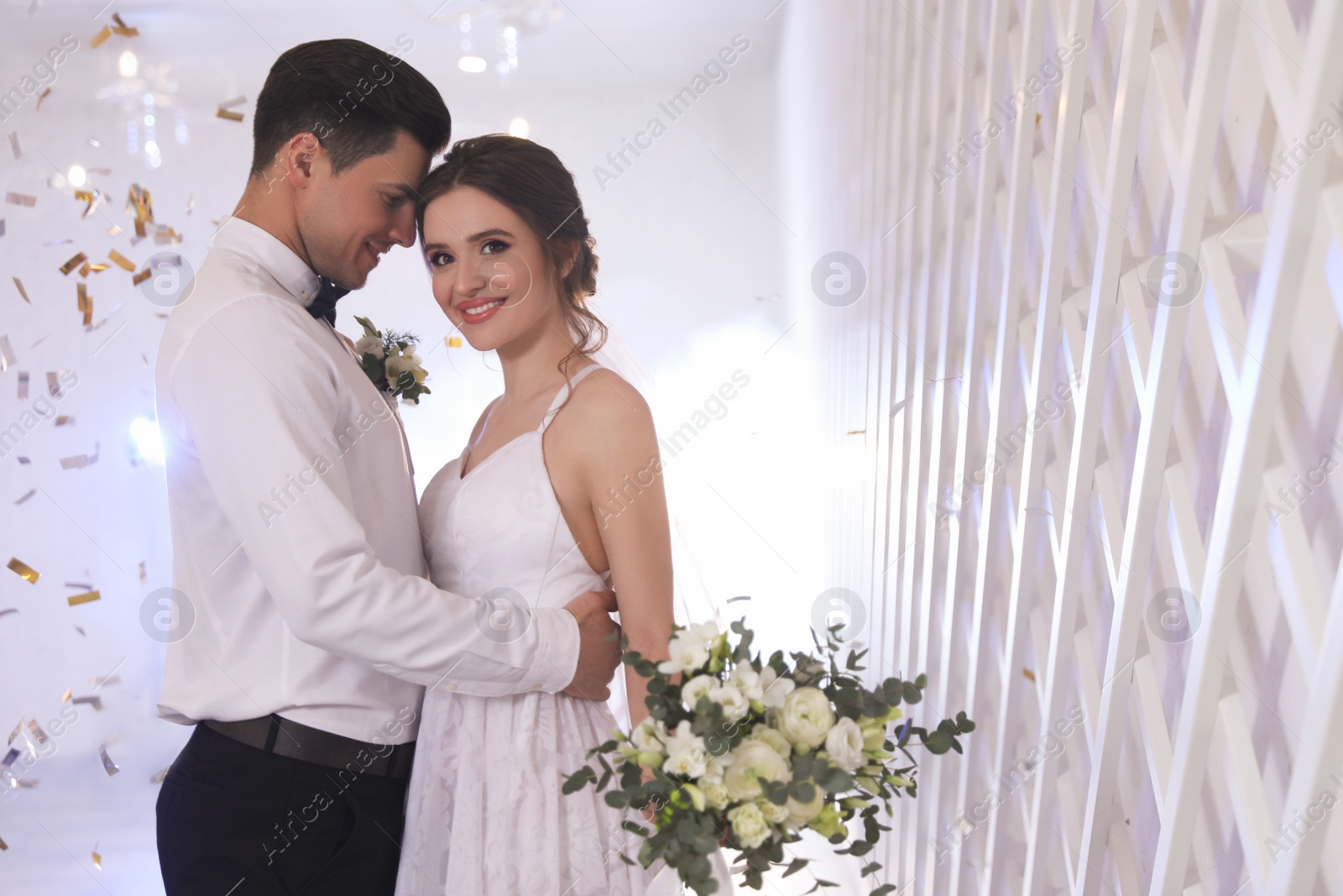 Photo of Happy newlywed couple dancing together in festive hall