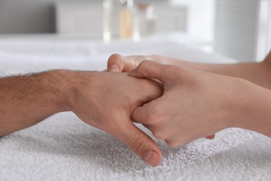 Photo of Man receiving hand massage in wellness center, closeup