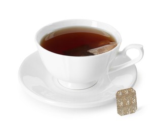 Photo of Brewing aromatic tea. Cup with teabag isolated on white