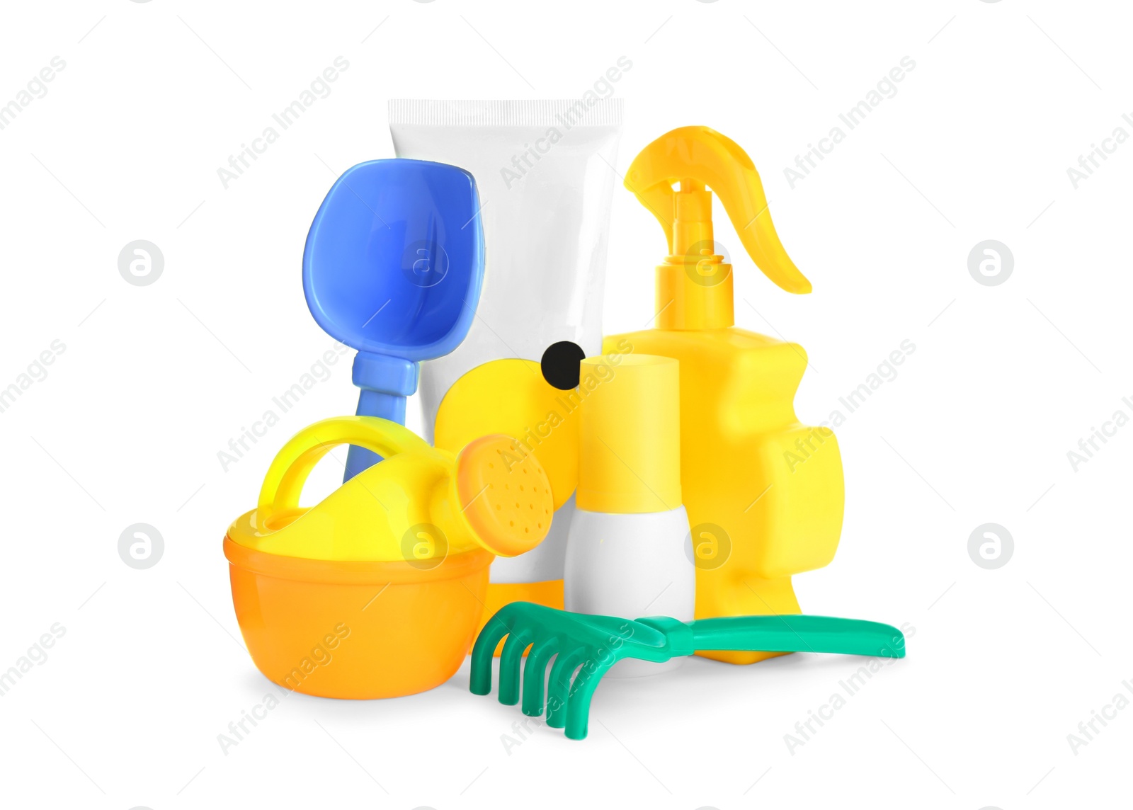 Photo of Different suntan products and plastic beach toys on white background