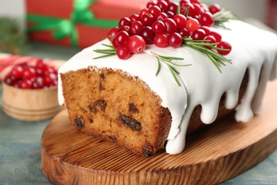 Photo of Traditional Christmas cake on light blue wooden table, closeup. Classic recipe