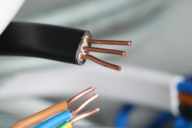 Photo of Colorful electrical wires on blurred background, closeup