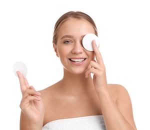 Beautiful young woman with cotton pads on white background