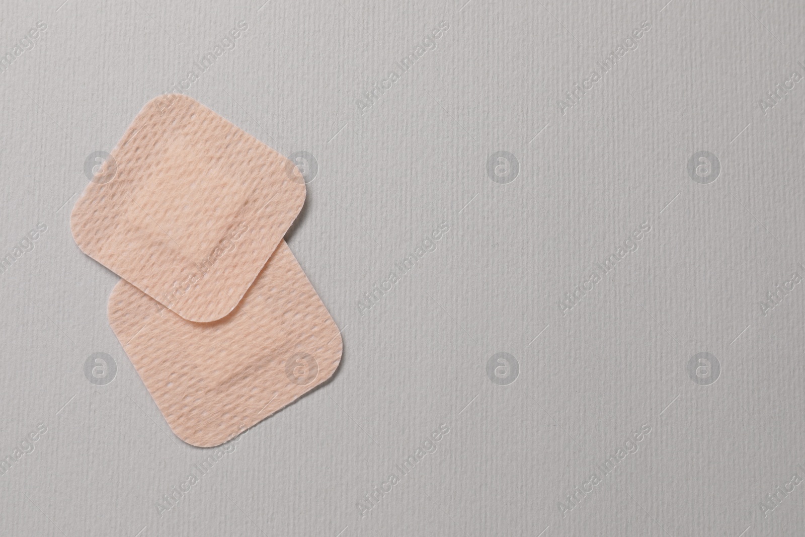 Photo of Contraceptive patches on light grey background, flat lay. Space for text