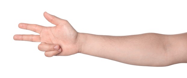 Photo of Playing rock, paper and scissors. Man making scissors with his fingers on white background, closeup