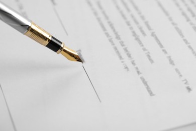 Photo of Signing document with fountain pen, closeup. Notary services