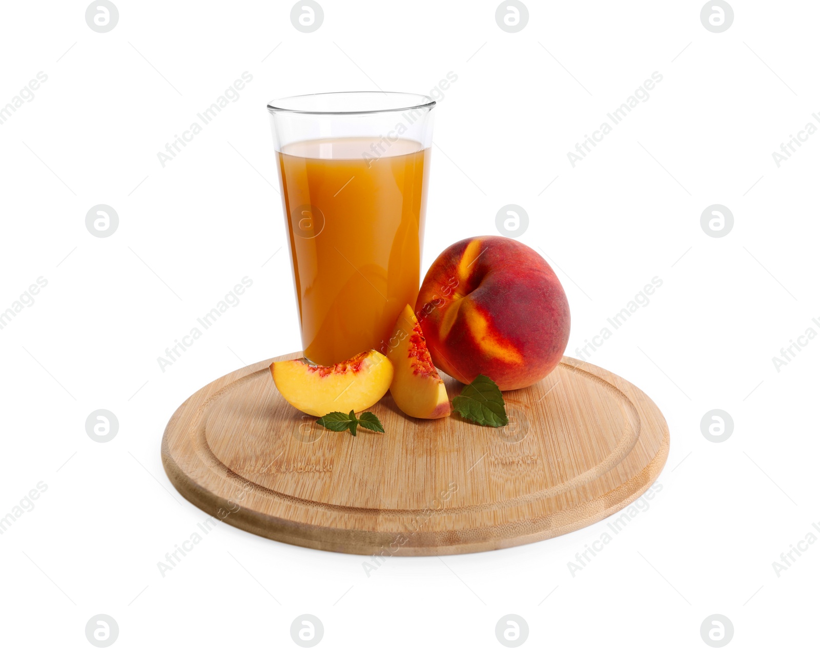 Photo of Wooden tray with glass of delicious peach juice, fresh fruits and leaves isolated on white