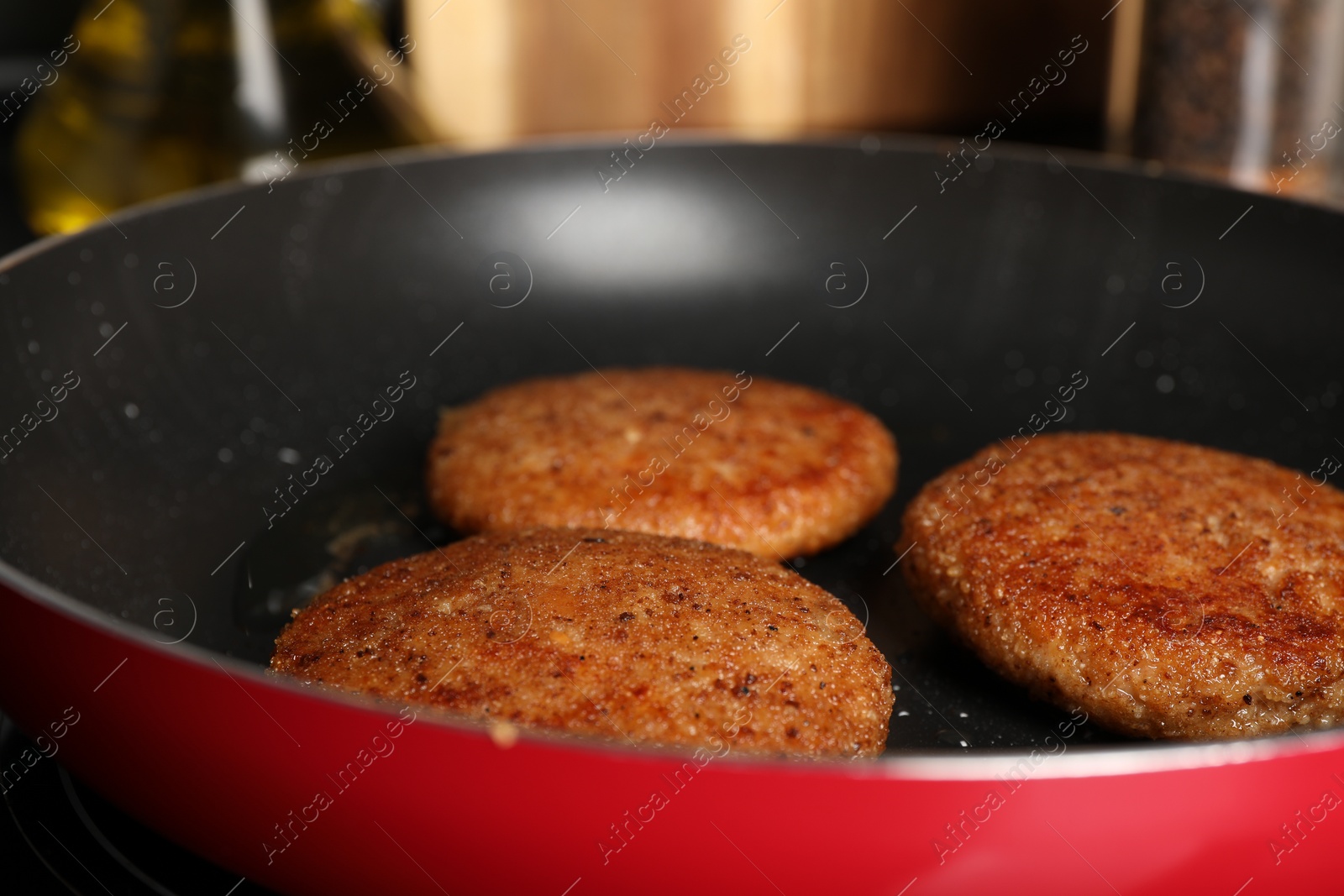 Photo of Cooking vegan cutlets in frying pan, closeup