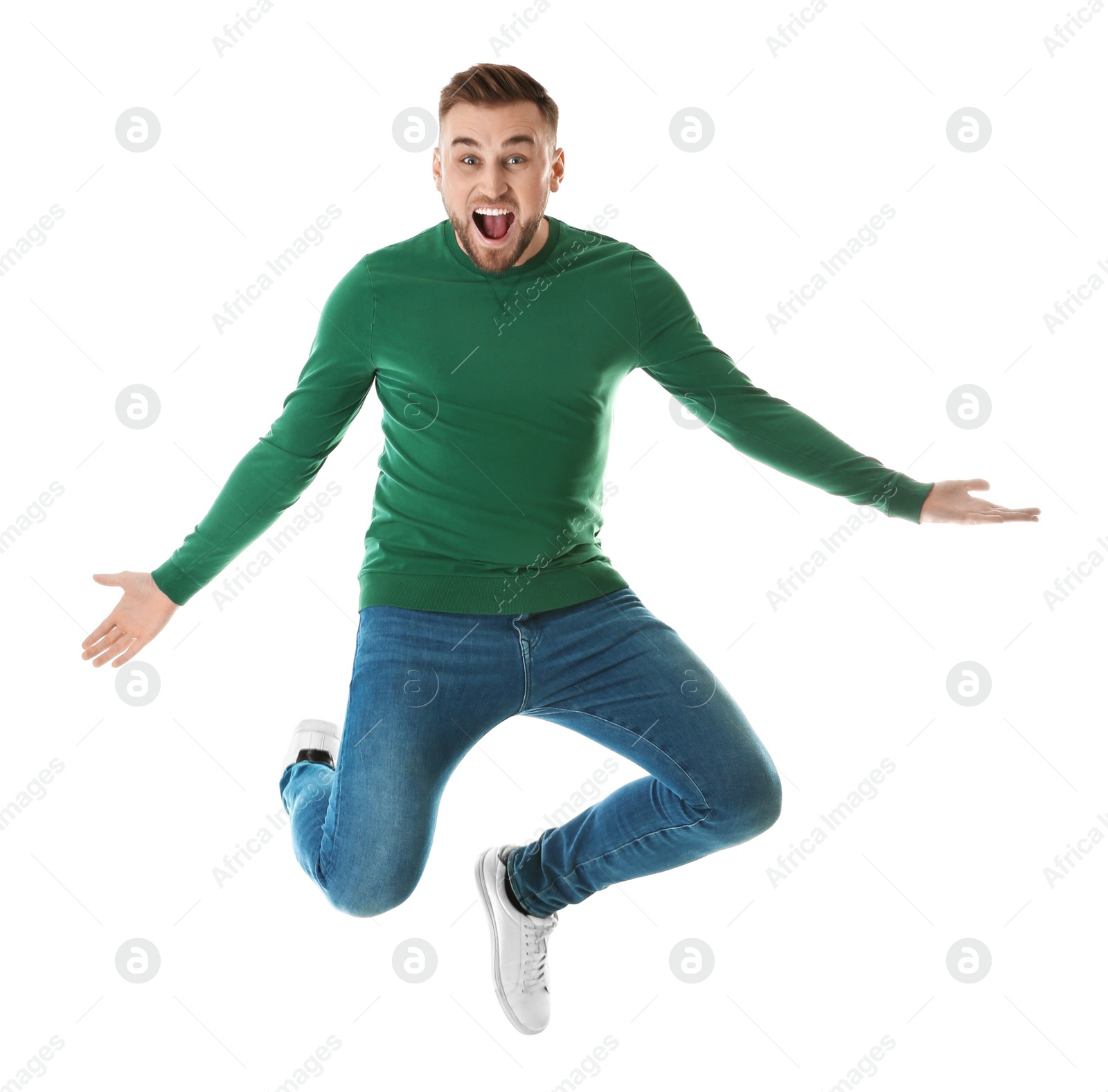 Photo of Full length portrait of emotional man jumping on white background