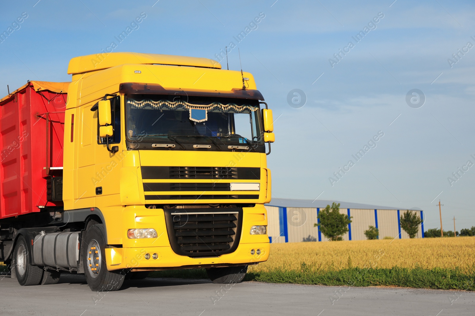 Photo of Modern truck on country road. Space for text