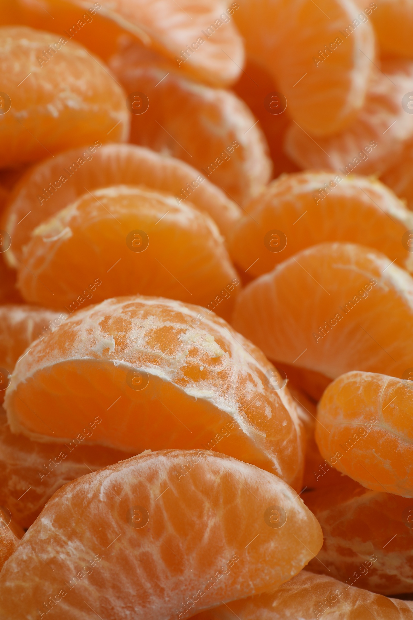 Photo of Delicious tangerine segments as background, closeup view