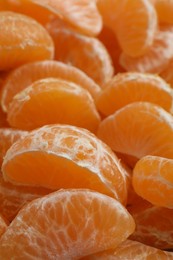 Delicious tangerine segments as background, closeup view