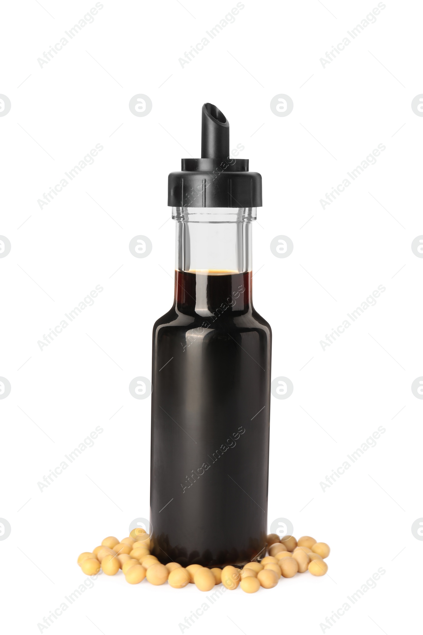 Photo of Bottle of soy sauce and soybeans on white background