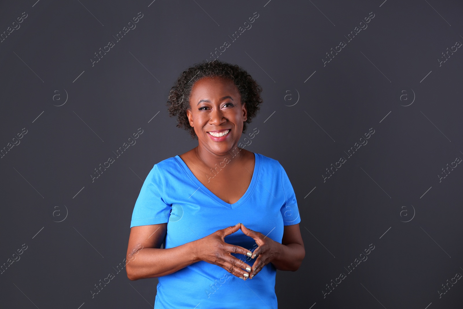 Photo of Portrait of happy African-American woman on black background