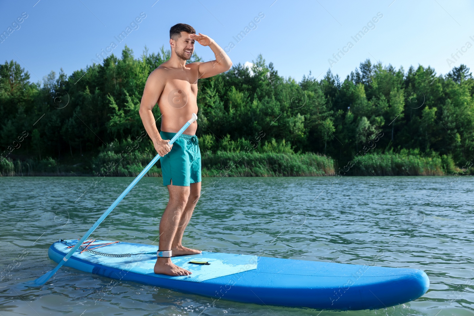 Photo of Man paddle boarding on SUP board in river