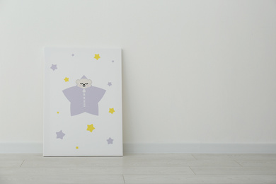 Adorable picture of animal and stars on floor near white wall, space for text. Children's room interior element