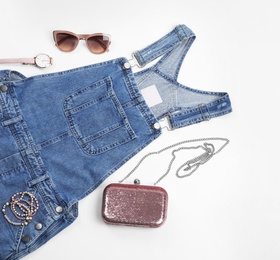 Flat lay composition with jean overall dress and accessories on white background