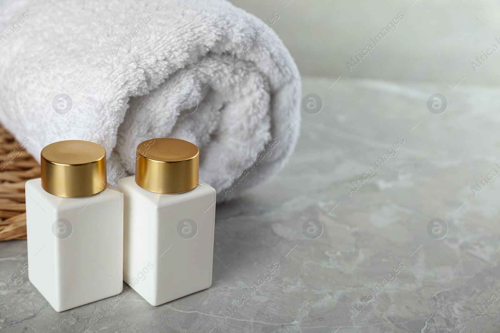 Photo of Composition with cosmetic products on grey stone table, space for text. Spa therapy