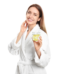 Young woman with glass of lemon water on white background