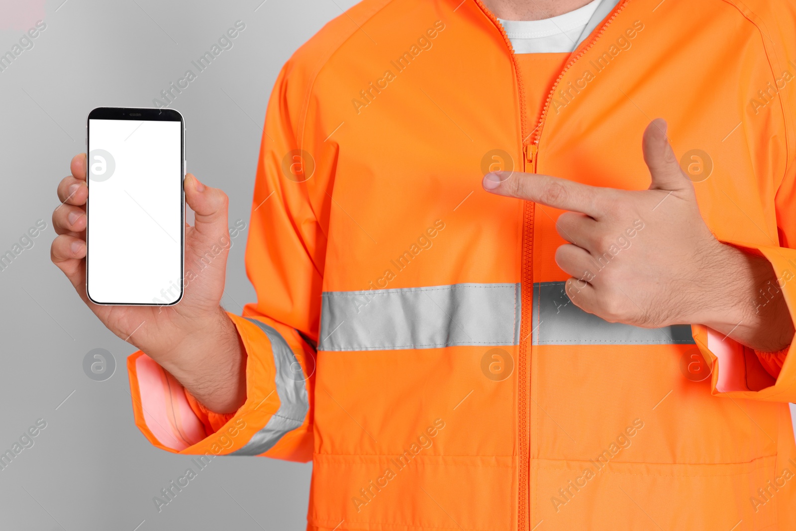 Photo of Man in reflective uniform with phone on white background, closeup