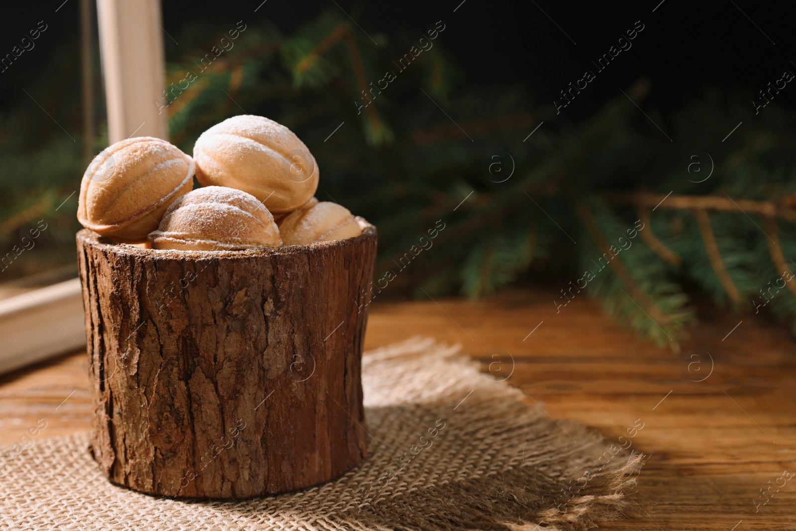 Photo of Homemade walnut shaped cookies with boiled condensed milk on wooden table, space for text