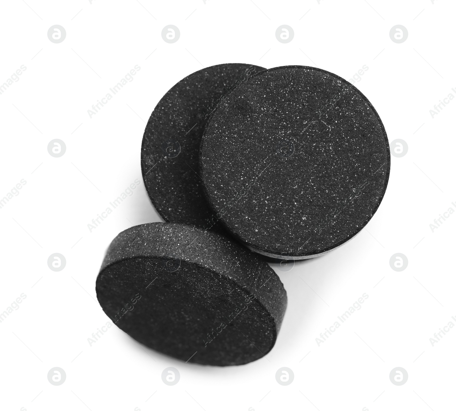 Photo of Black pills on white background, top view