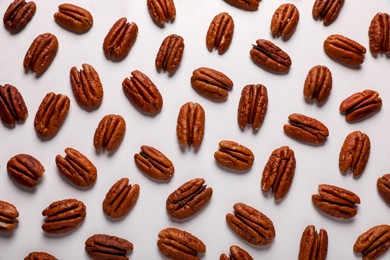 Photo of Delicious fresh pecan nuts on white background, flat lay