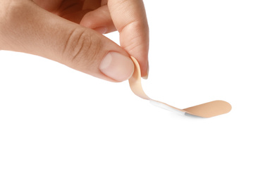 Photo of Woman putting sticking plaster on white background. First aid item
