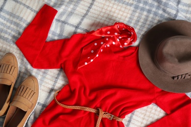 Flat lay composition with cashmere sweater and hat on soft plaid