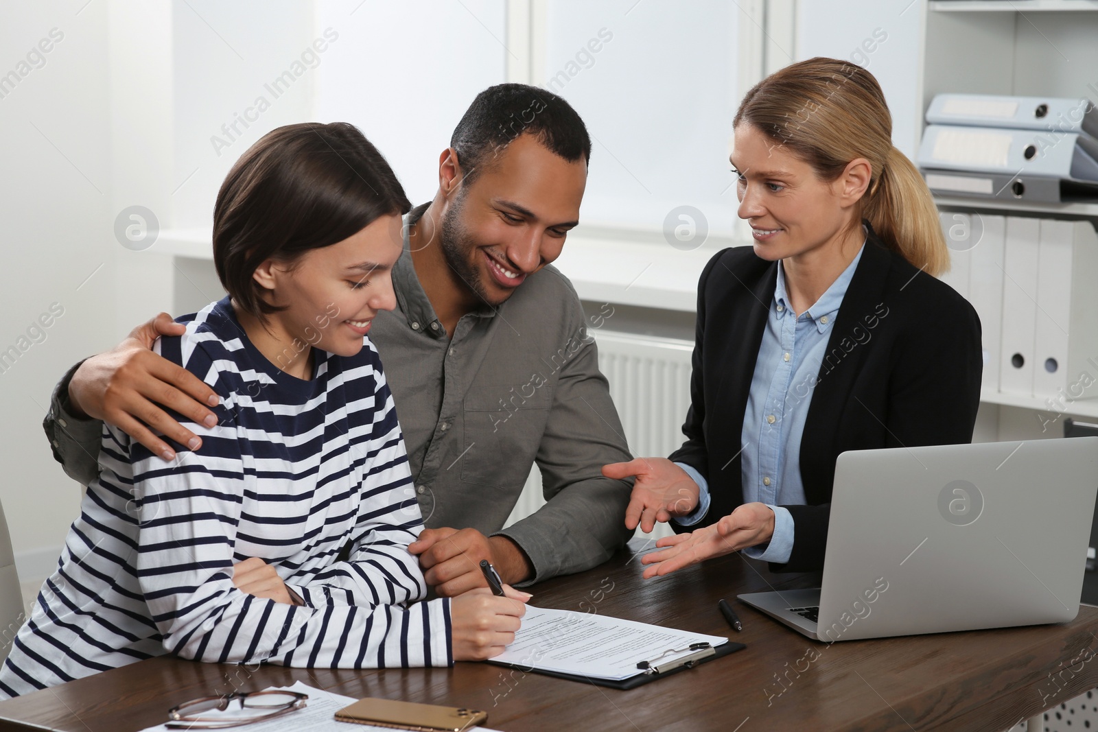 Photo of Couple consulting with professional notary in office