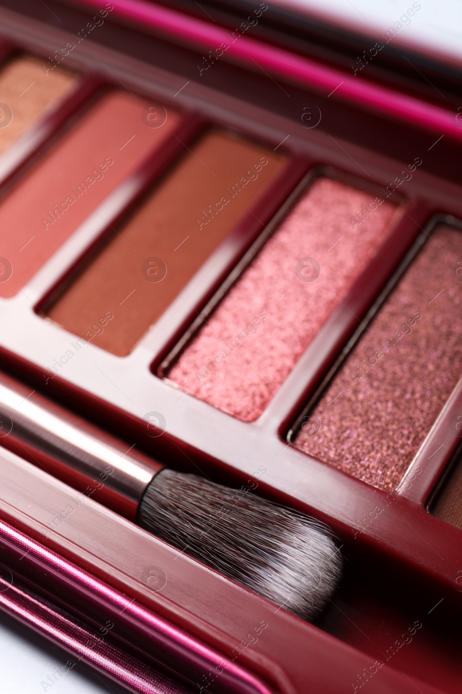 Photo of Beautiful eye shadow palette and brush on table, closeup