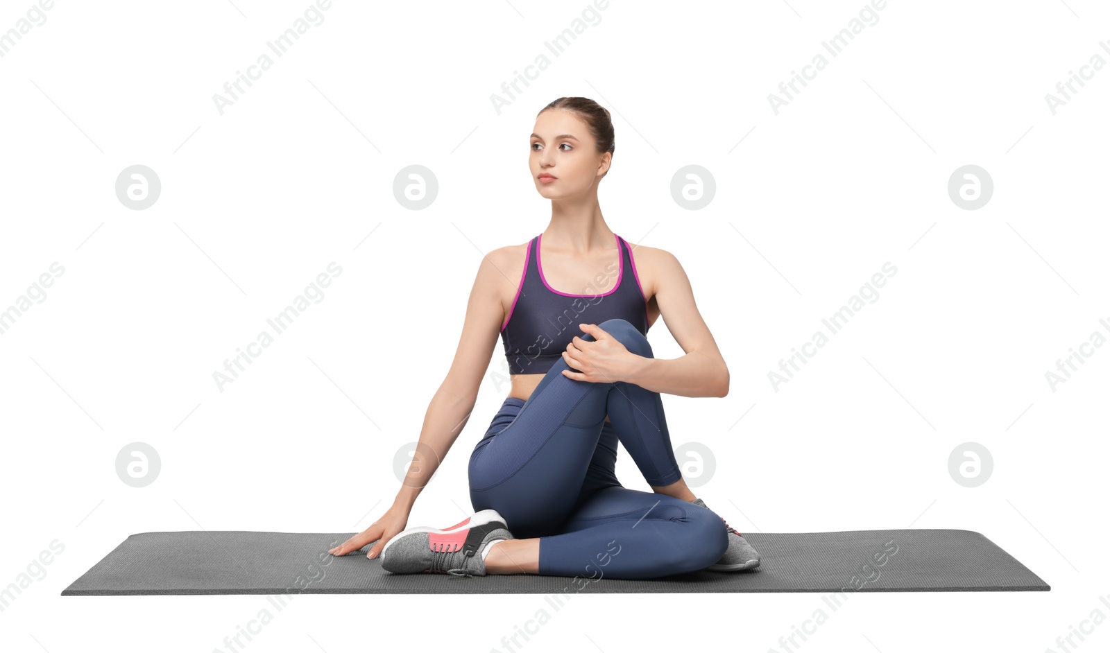 Photo of Yoga workout. Young woman stretching on white background