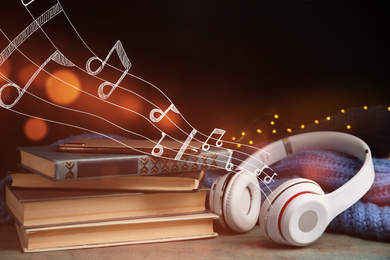 Image of Books, headphones and mobile phone on wooden table 